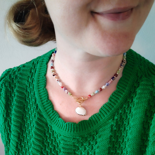 Woman wearing a colorful shell charm necklace