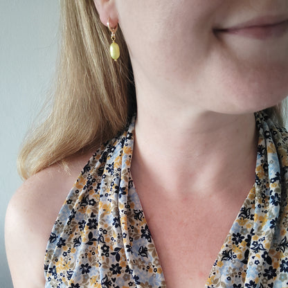 Woman wearing baroque freshwater pearl drop earrings.
