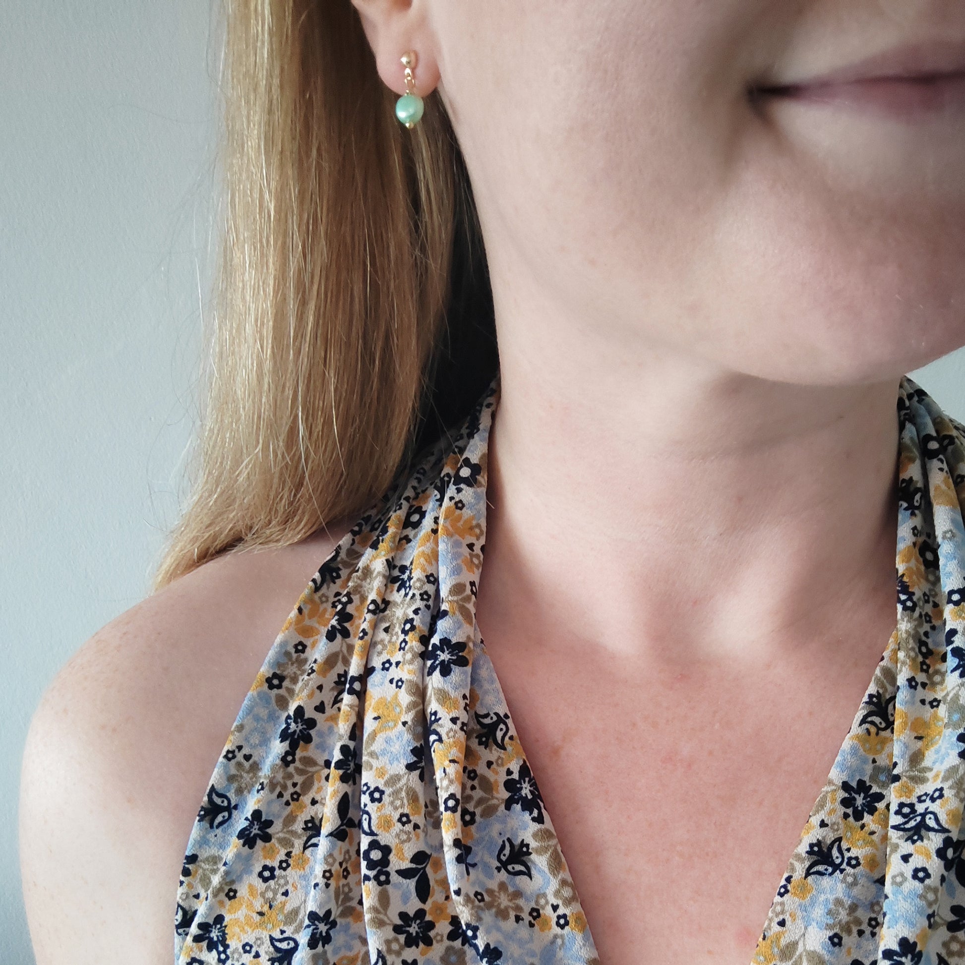 Woman wearing baroque freshwater pearl drop earrings.