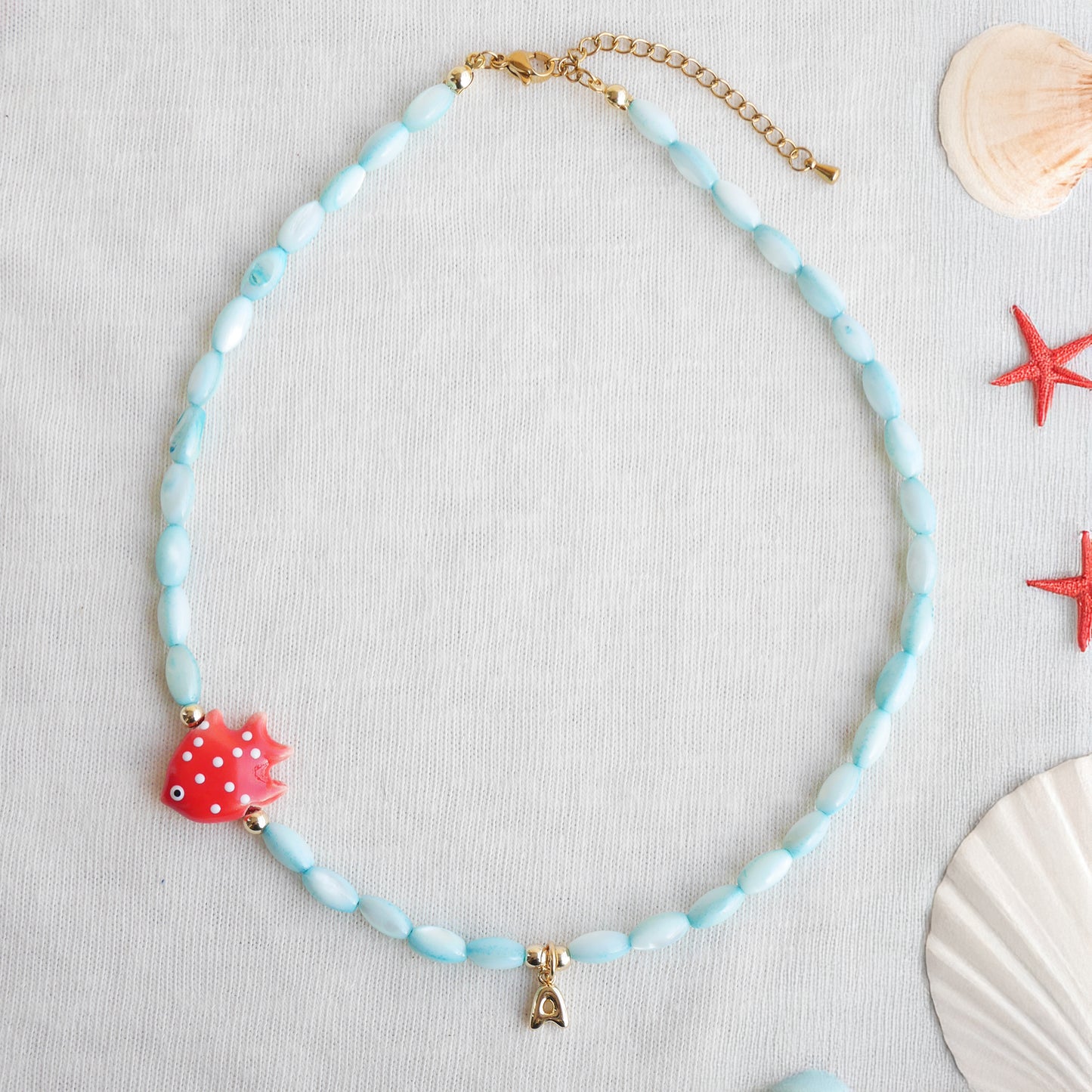 Colorful summer necklace – turquoise shell beads, red fish and bubble initial