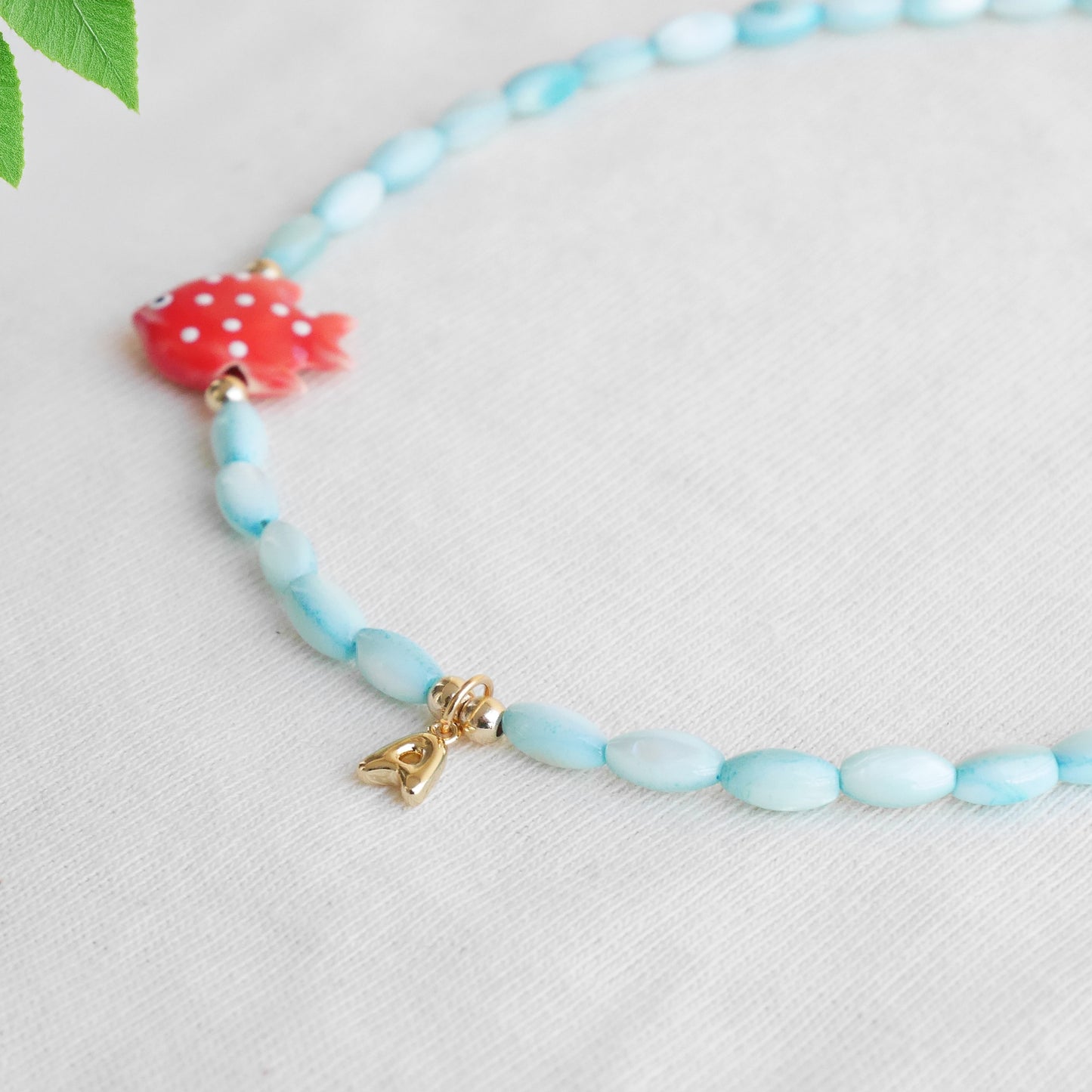 Colorful summer necklace – turquoise shell beads, red fish and bubble initial