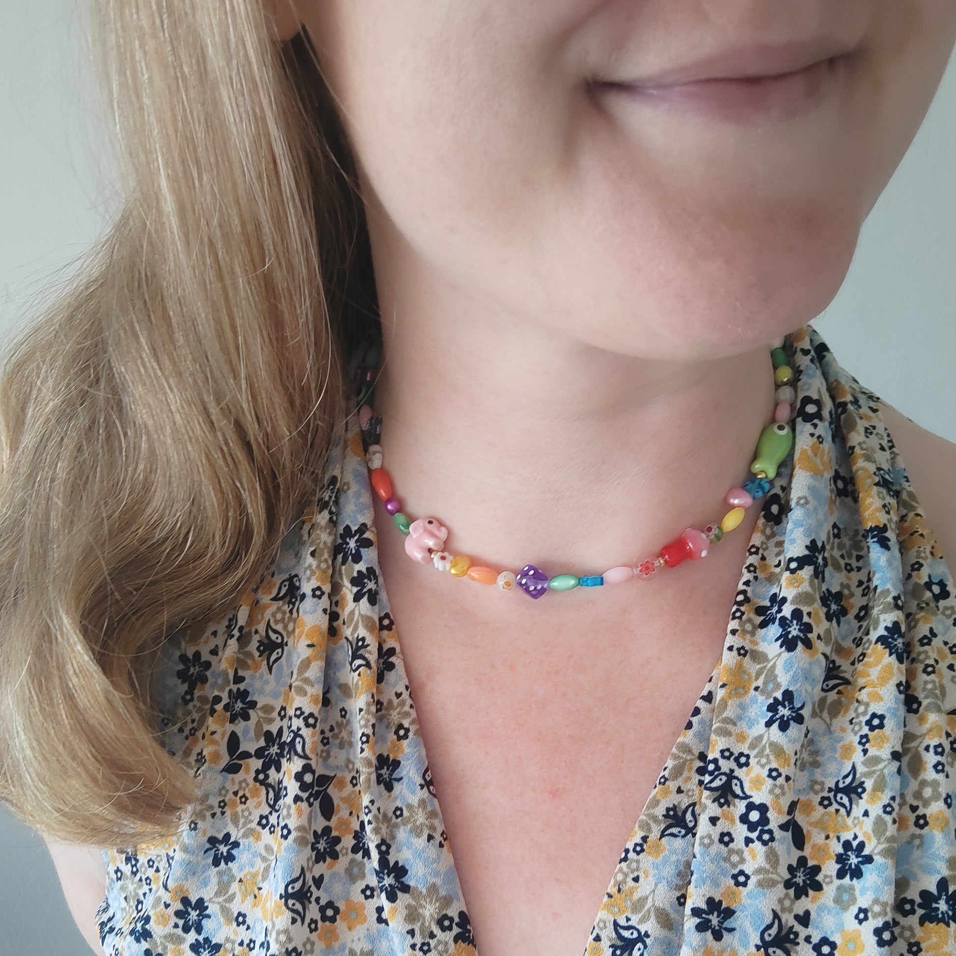 Woman wearing a colorful mixed beads necklace.