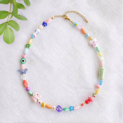 Colorful mixed beads necklace on a white cloth.