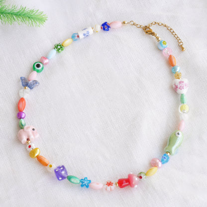Colorful mixed beads necklace on a white cloth.