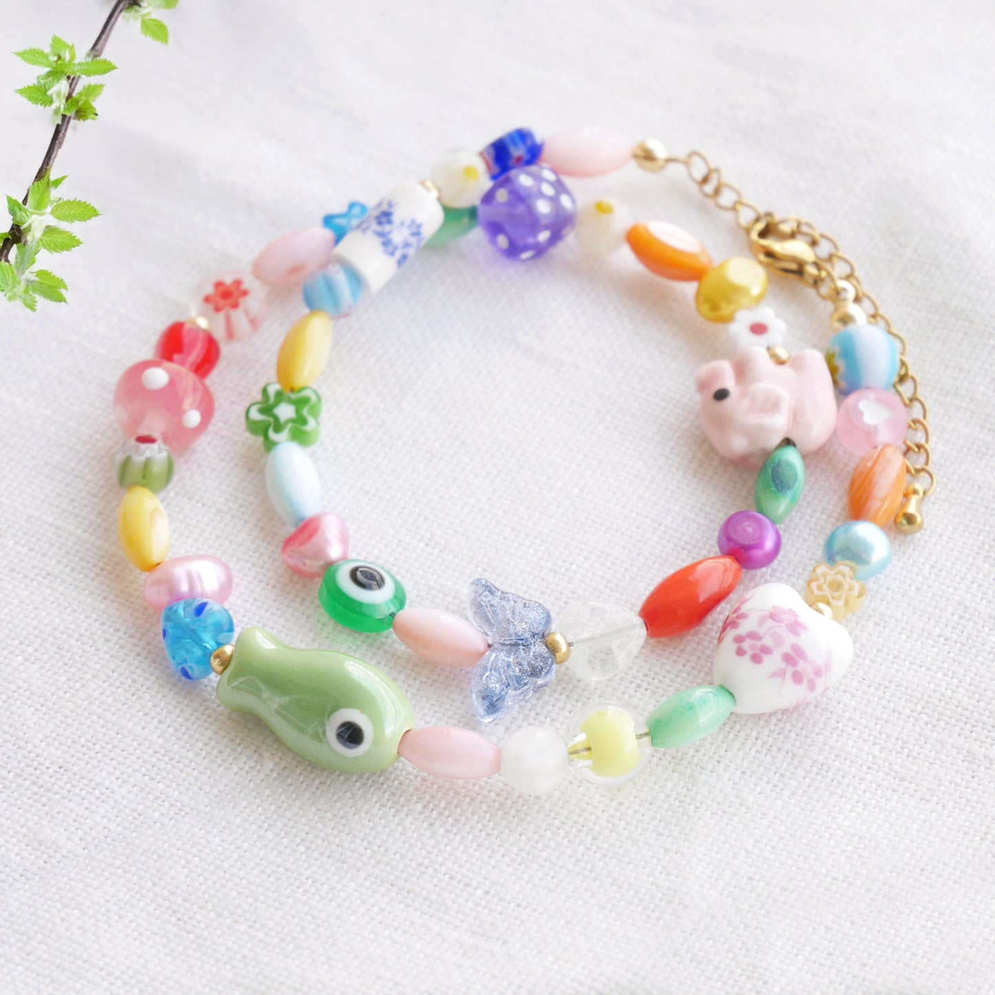 Colorful mixed beads necklace on a white cloth.