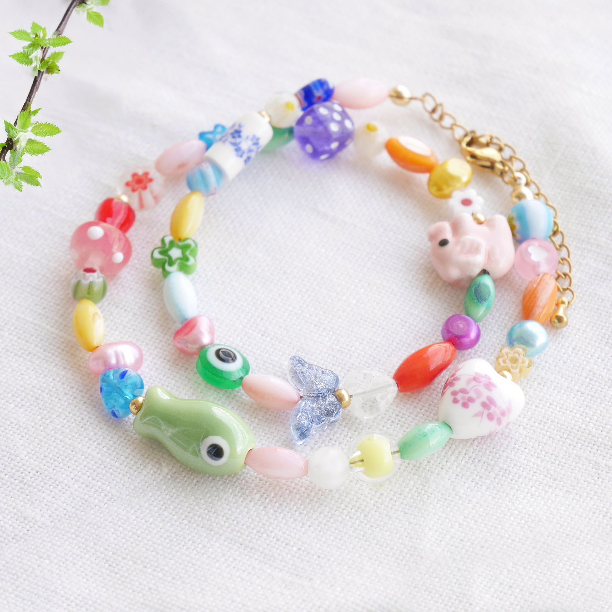 Colorful mixed beads necklace on a white cloth.