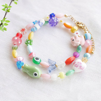Colorful mixed beads necklace on a white cloth.