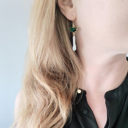 Woman wearing green biwa pearl earrings.