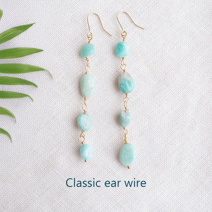 Amazonite gemstone long dangle earrings on a white cloth.