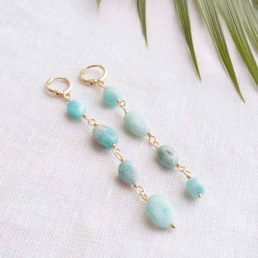Amazonite gemstone long dangle earrings on a white cloth.