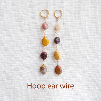 Long jasper stone dangle earrings in earthy mookaite colors, on a white cloth.