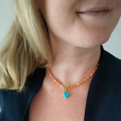 Orange beaded necklace - blue porcelain heart charm, toggle clasp