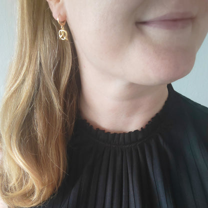 woman wearing pretzel earrings