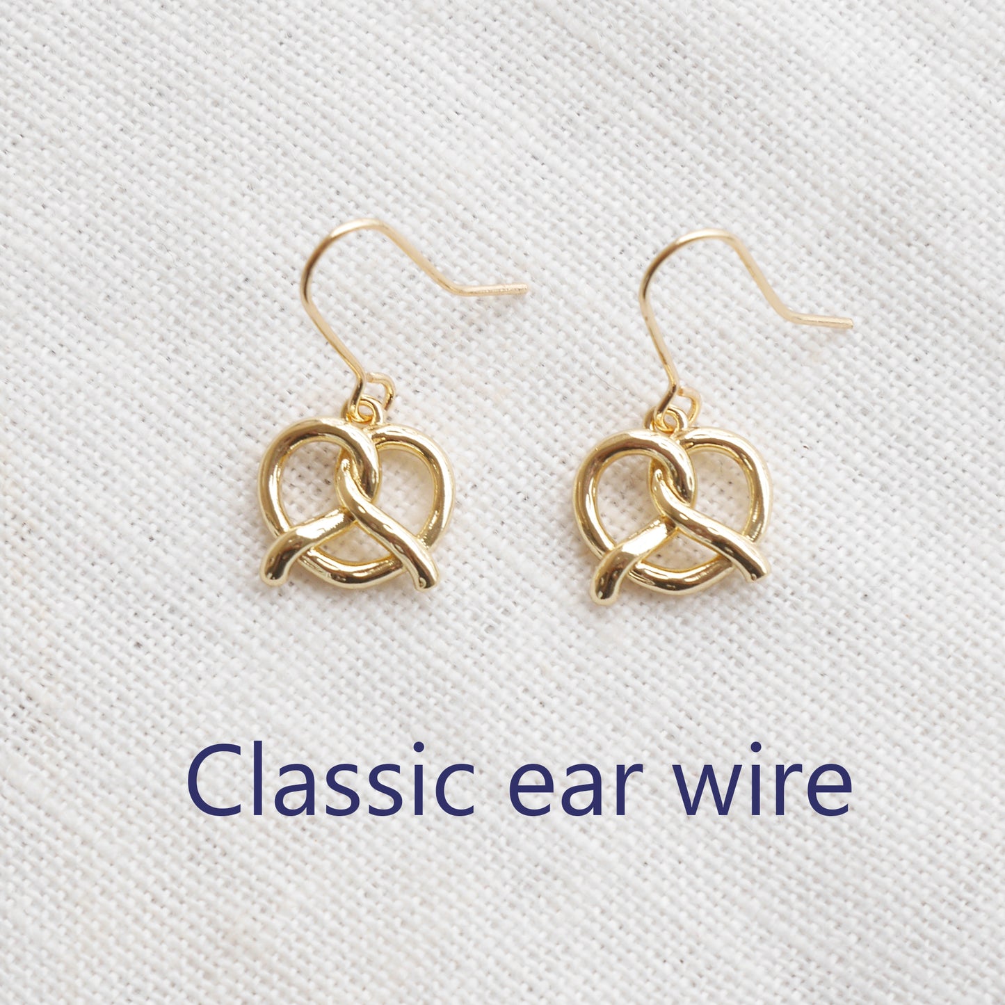 pretzel earrings on a white cloth.