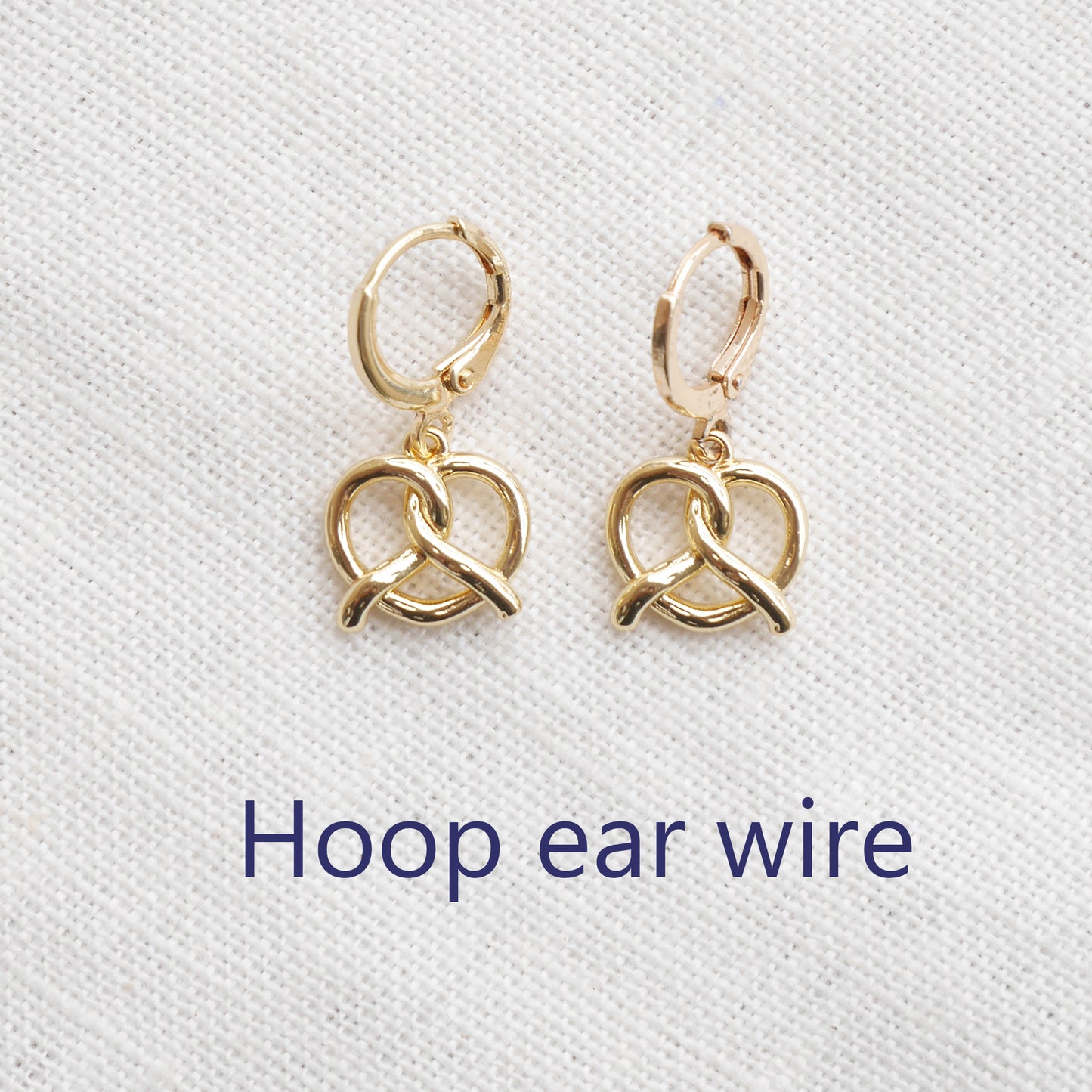 pretzel earrings on a white cloth.