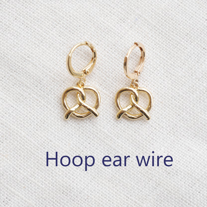 pretzel earrings on a white cloth.