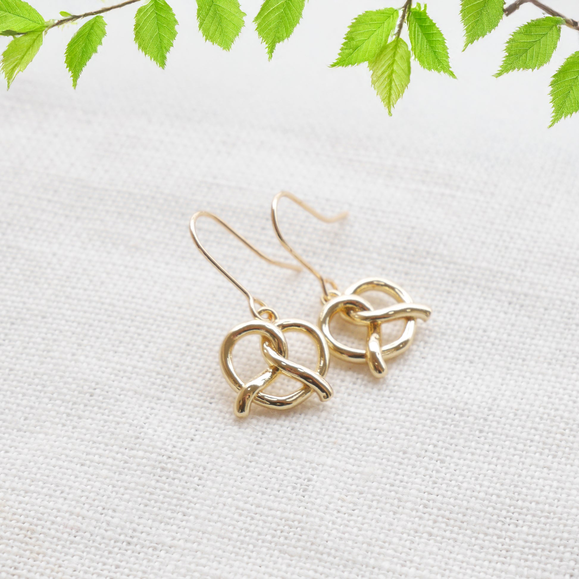 pretzel earrings on a white cloth.