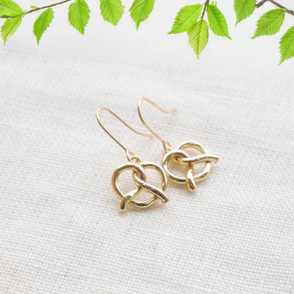pretzel earrings on a white cloth.