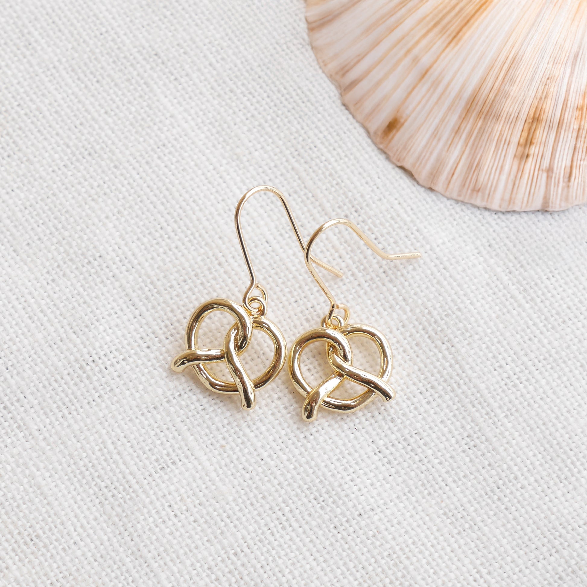 pretzel earrings on a white cloth.