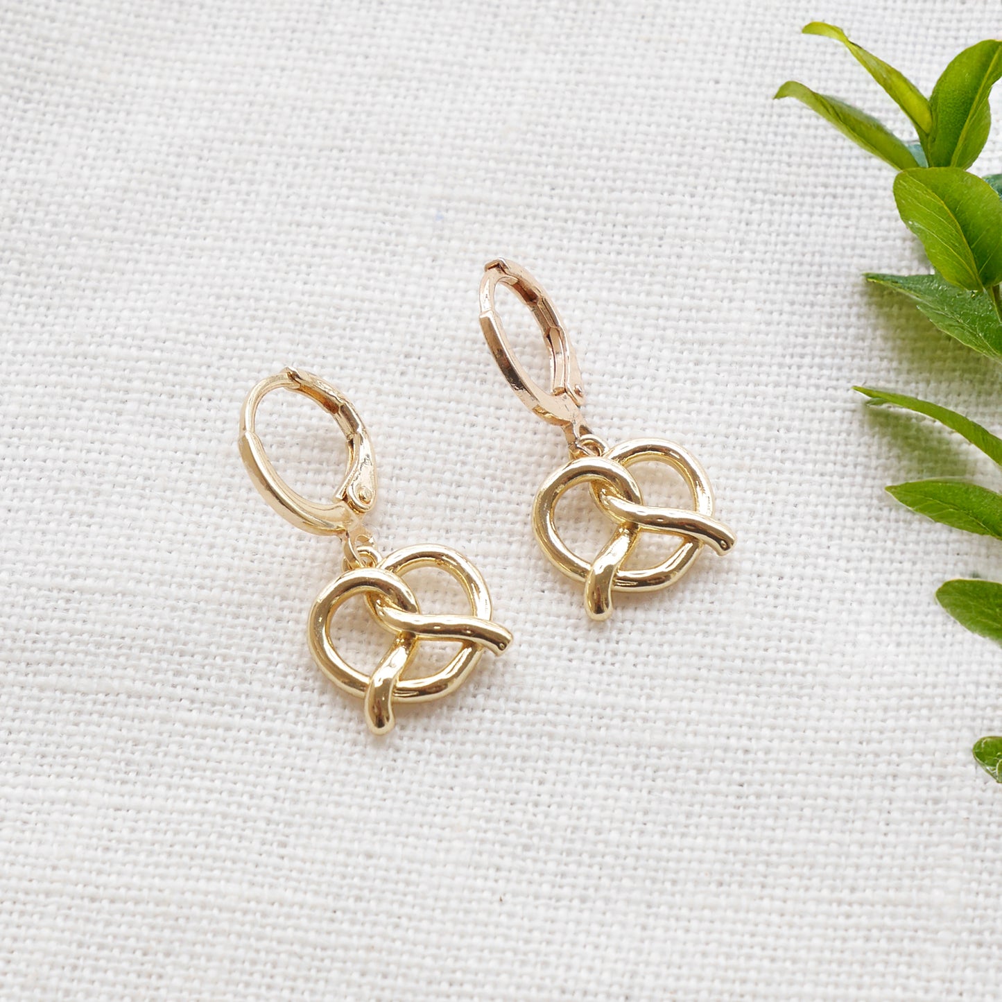 pretzel earrings on a white cloth.