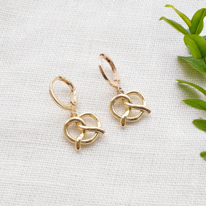 pretzel earrings on a white cloth.