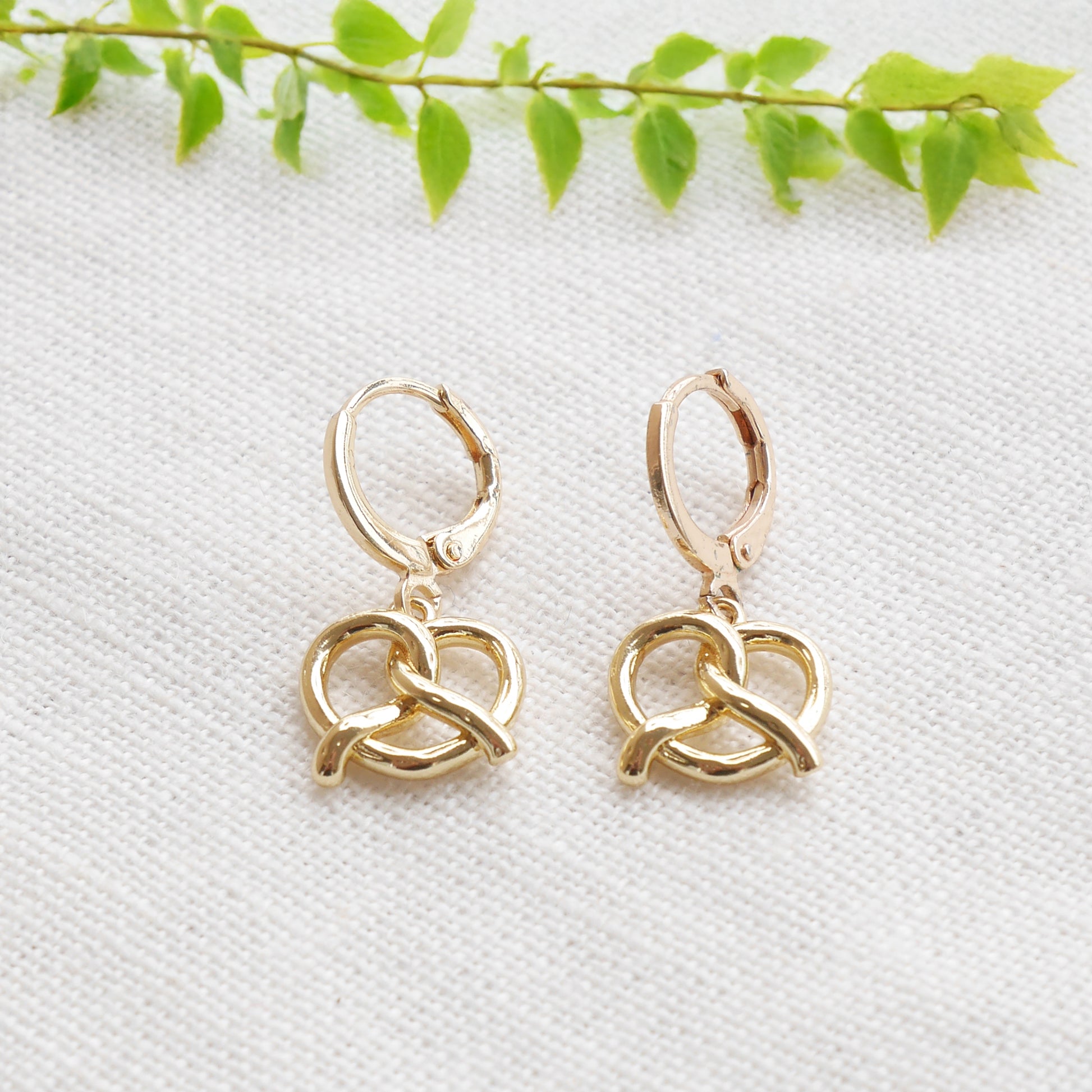 pretzel earrings on a white cloth.