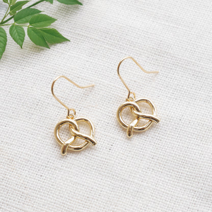 pretzel earrings on a white cloth.