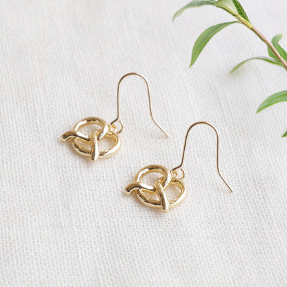 pretzel earrings on a white cloth.