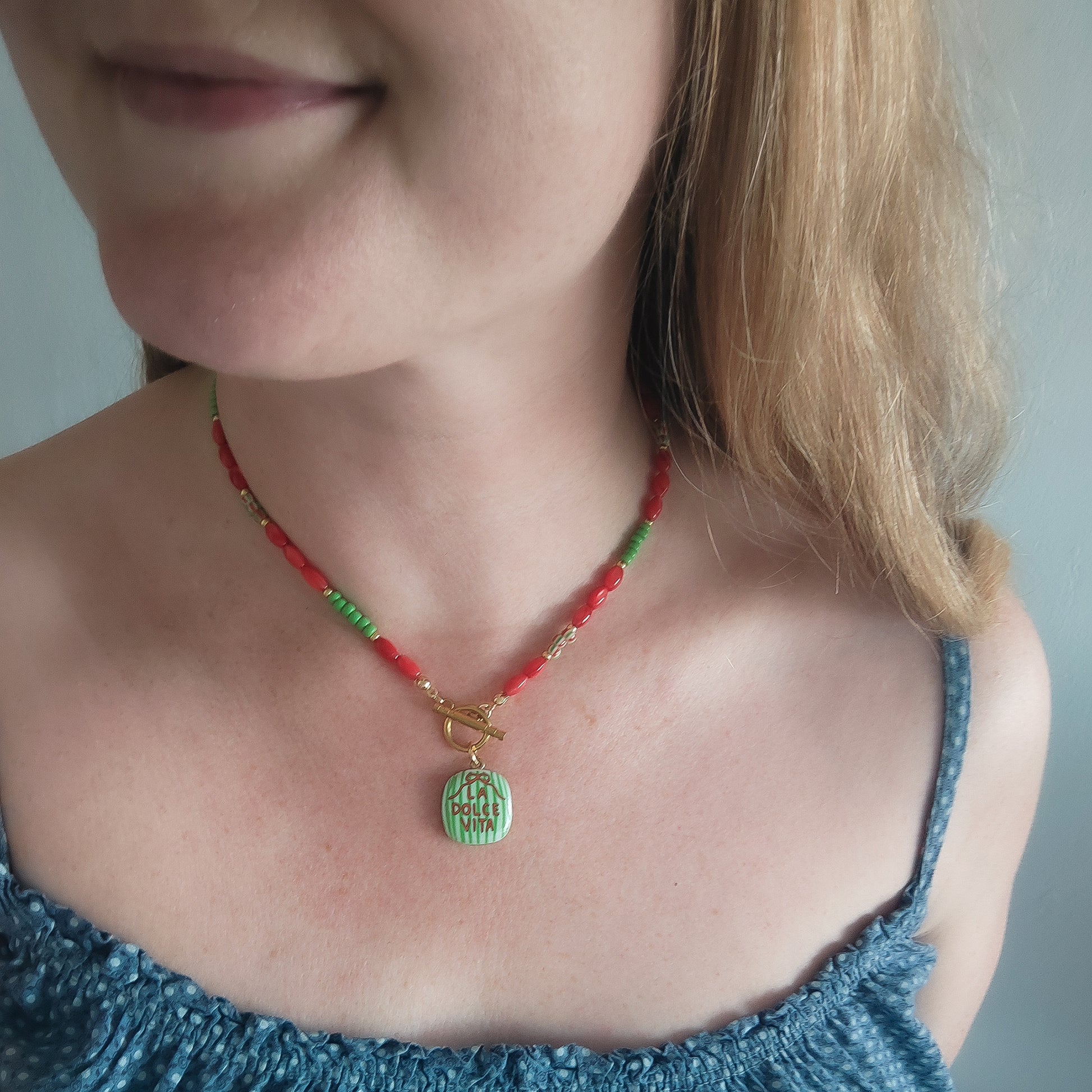 Woman wearing La dolce vita necklace.